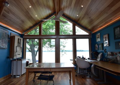 interior of blue and wooden modern office over looking a lake