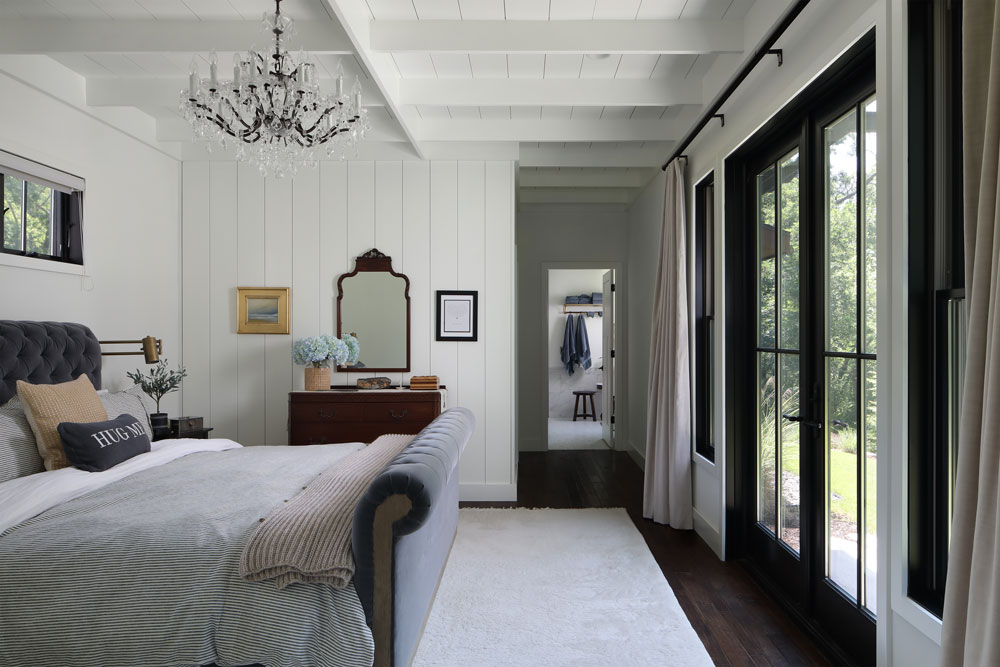 Guest space with bed, chandelier, and patio exterior doors